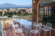 Apartment in Sorrento: Terrace with table and chairs and a beautiful sea-view of Chiara Apartment in Sorrento